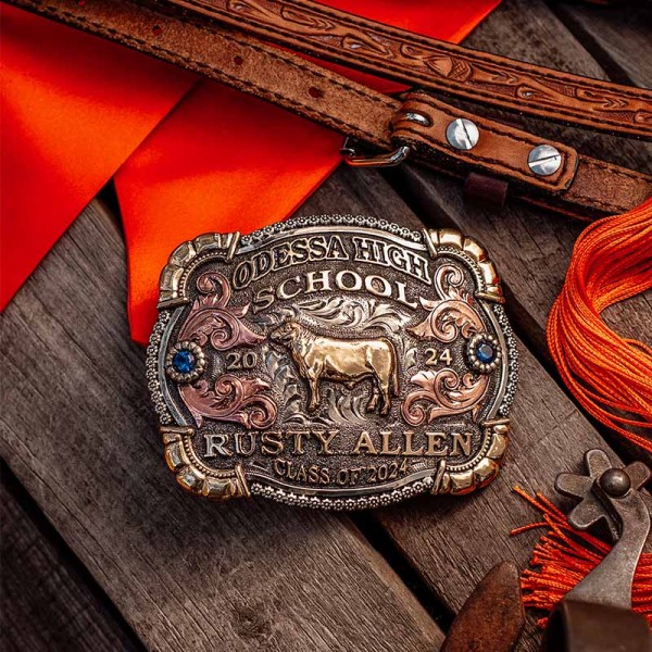 A custom graduation belt buckle for Odessa High School Class of 2024 with personalized name featuring a bronze cow figure 